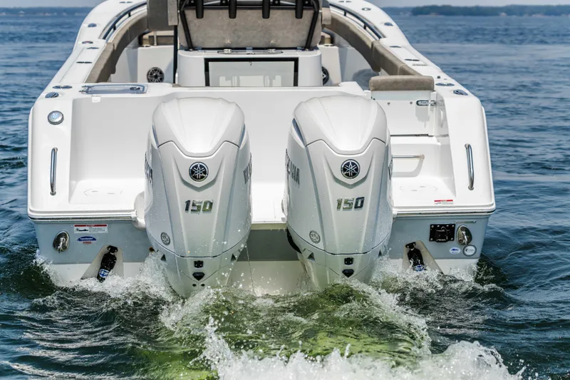 Slide: The Image of 2026 Sea Hunt Gamefish 25 with dual Yamaha 150 engines on water. - 26