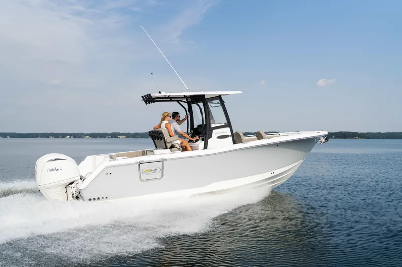 Slide: The Image of 2026 Sea Hunt Gamefish 25 cruising on a calm lake under a clear blue sky. - 28