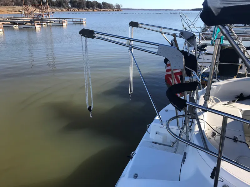 Slide: The Image of 1997 Hunter 376 sailboat docked at marina, featuring blue covers and sleek design. - 10