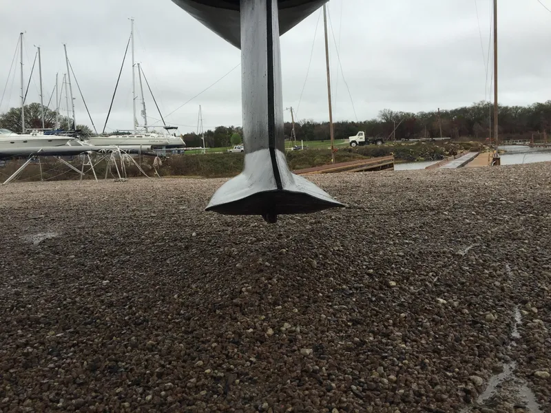 Slide: The Image of Hunter 376 sailboat from 1997 on a boat lift, showing keel and hull. - 17