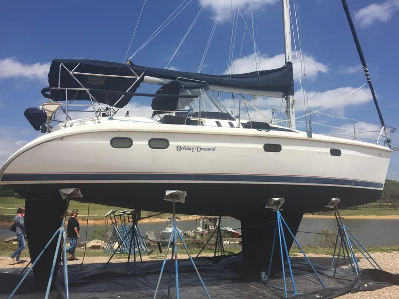 Slide: The Image of Keel of a 1997 Hunter 376 sailboat on gravel, with other boats in the background. - 18