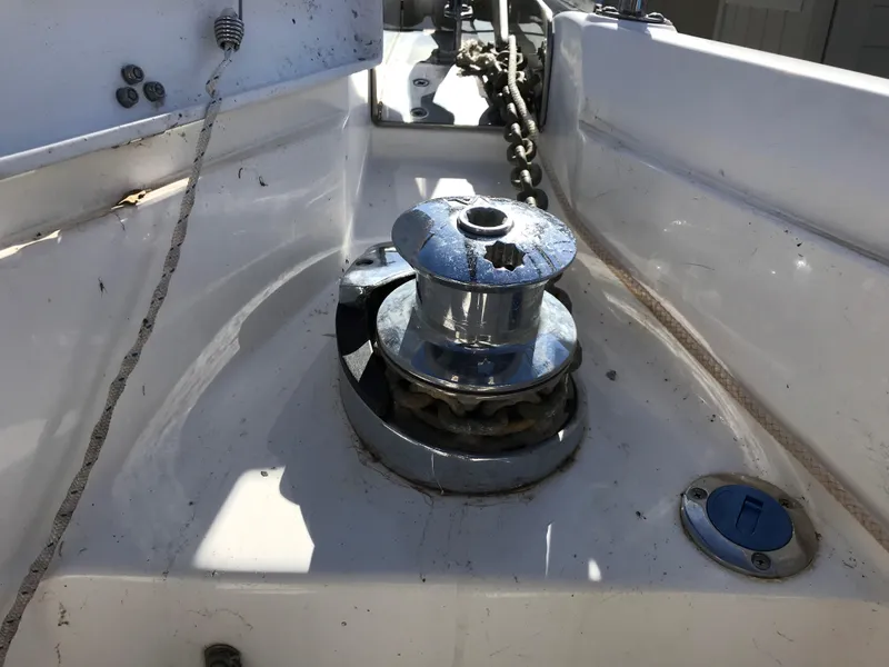 Slide: The Image of Interior of a 1997 Hunter 376 sailboat with beige seating and wooden cabinetry. - 25