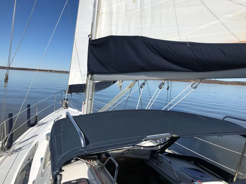 Slide: The Image of 1997 Hunter 376 sailboat interior with control panel and small fan on wooden desk. - 26