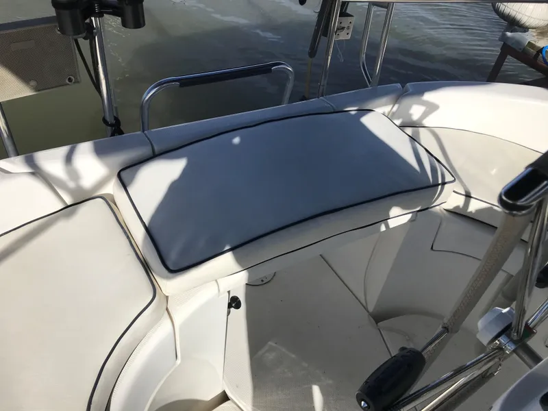 Slide: The Image of Interior of 1997 Hunter 376 sailboat with beige seating and decorative blue pillows. - 28