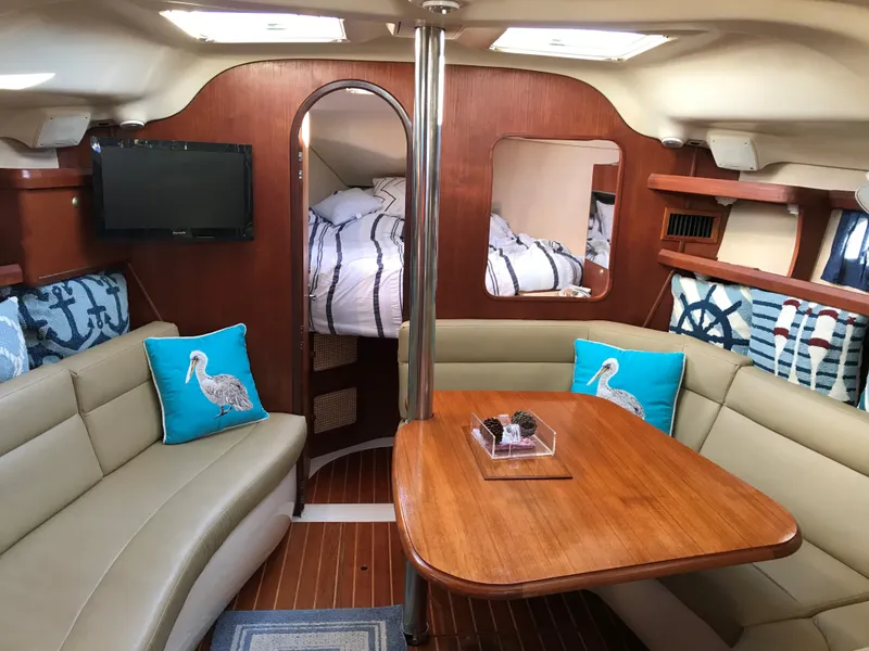 Slide: The Image of 1997 Hunter 376 yacht kitchen with wooden cabinetry and stainless steel stove. - 34