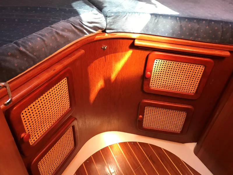 Slide: The Image of Interior cabin of a 1997 Hunter 376 sailboat with a spacious bed and wooden accents. - 41