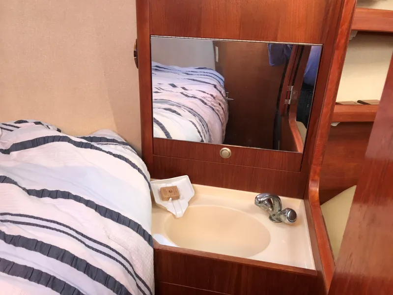 Slide: The Image of Engine compartment of a 1997 Hunter 376 sailboat, showcasing mechanical components. - 47