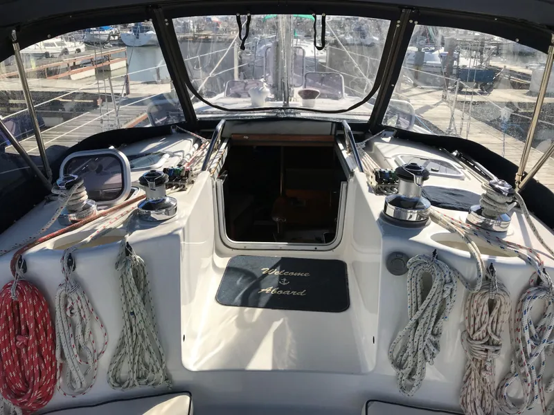 Slide: The Image of 1997 Hunter 376 sailboat docked at marina with other boats in background. - 7