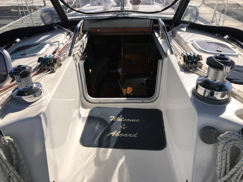 Slide: The Image of 1997 Hunter 376 sailboat docked at a marina, featuring a sleek design and blue covers. - 8