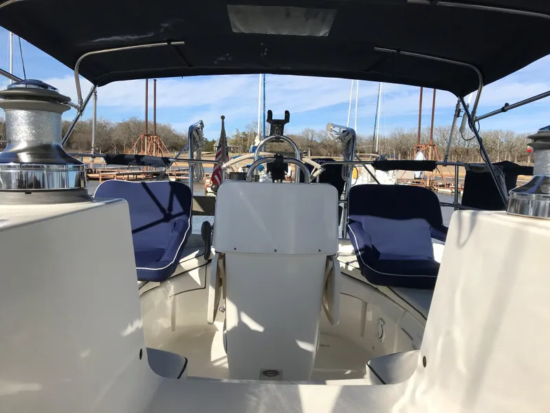 Slide: The Image of 1997 Hunter 376 sailboat docked at marina, featuring covered cockpit and rigging. - 9