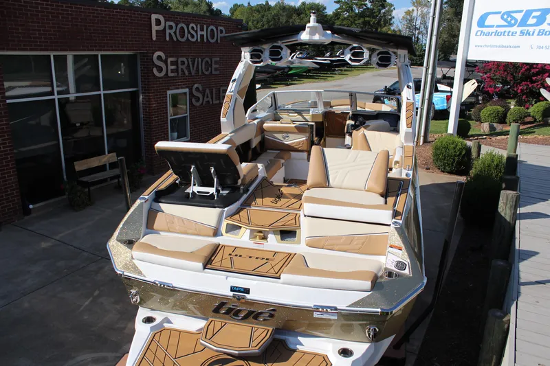 Slide: The Image of 2026 Tigé Ultré 25ZX boat at dealership, showcasing luxurious seating and modern design. - 14