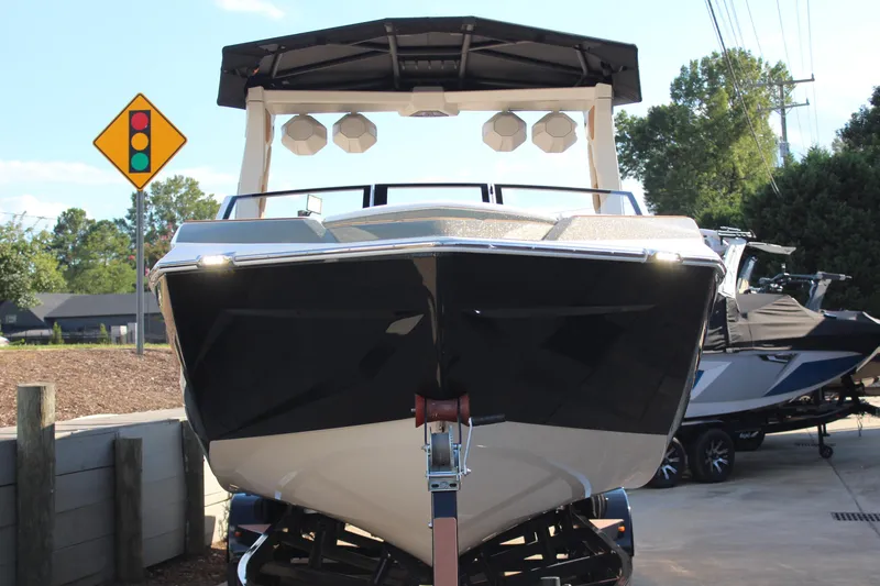 Slide: The Image of 2026 Tigé Ultré 25ZX boat on trailer, front view, near traffic sign. - 19