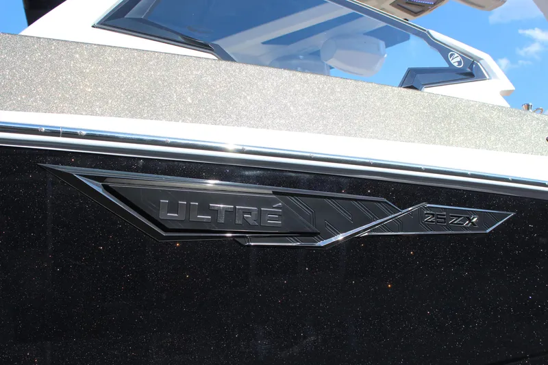 Slide: The Image of 2026 Tigé Ultré 25ZX boat emblem on sleek black exterior. - 20