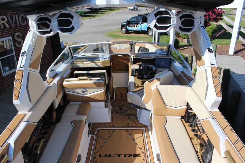 Slide: The Image of 2026 Tigé Ultré 25ZX boat interior with luxurious seating and advanced audio system. - 25