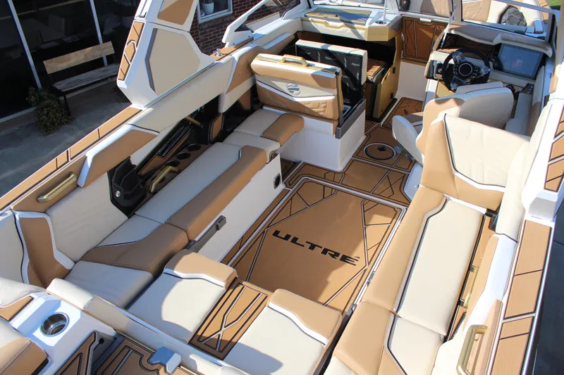 Slide: The Image of 2026 Tigé Ultré 25ZX boat interior with luxurious tan and white seating. - 26