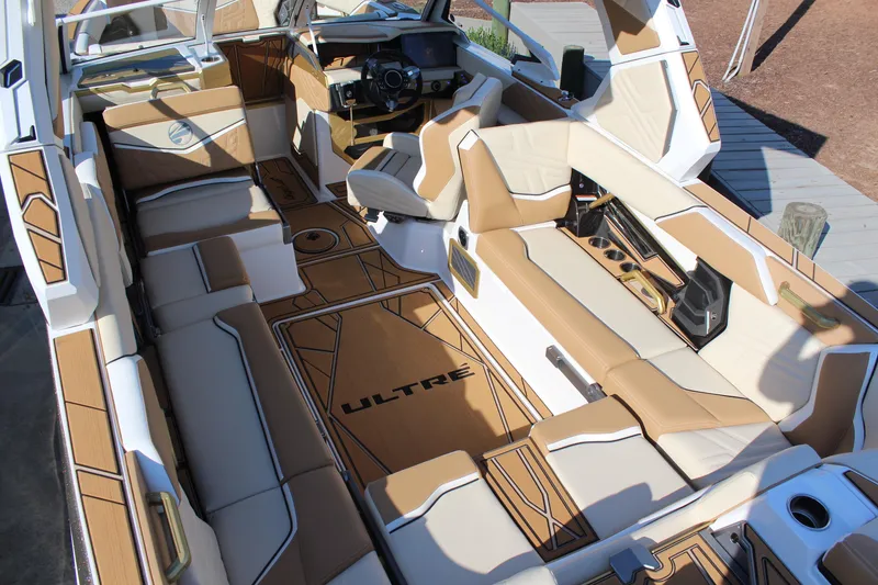 Slide: The Image of 2026 Tigé Ultré 25ZX boat interior with luxurious tan and white seating and modern dashboard. - 28