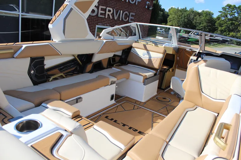 Slide: The Image of Luxurious interior of 2026 Tigé Ultré 25ZX boat with tan and white seating. - 29