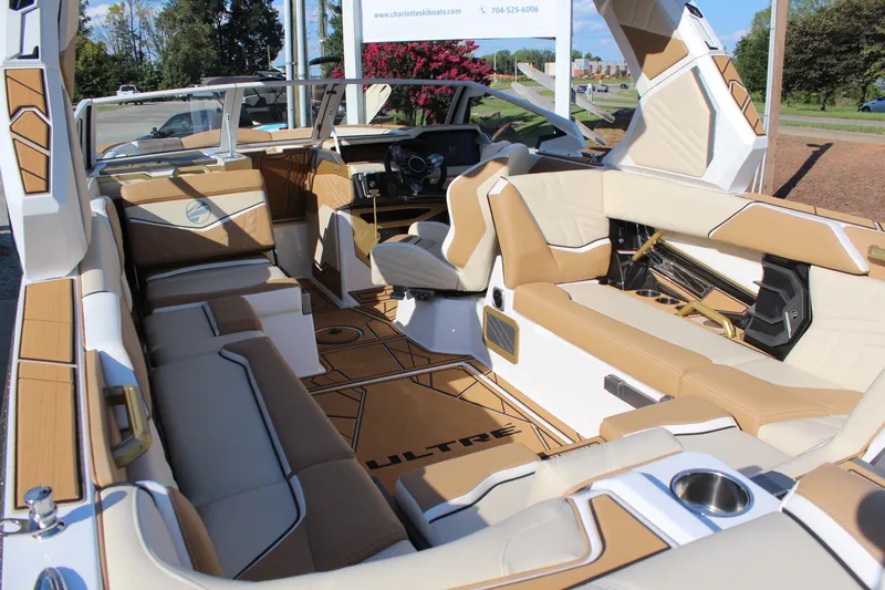 Slide: The Image of 2026 Tigé Ultré 25ZX boat interior with luxurious tan and white seating, modern dashboard. - 30