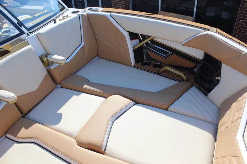 Slide: The Image of Luxurious interior of 2026 Tigé Ultré 25ZX boat with tan and white seating. - 8