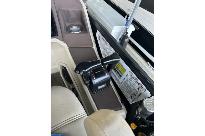 Slide: The Image of 2019 Premier 290 Grand View boat control panel with throttle and warning labels. - 10