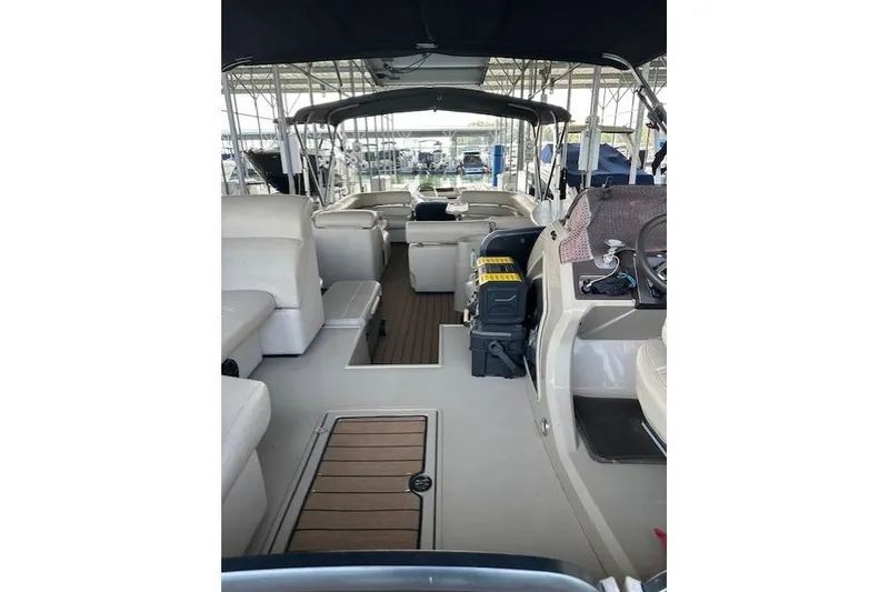 Slide: The Image of 2019 Premier 290 Grand View boat interior with seating and helm under canopy. - 12
