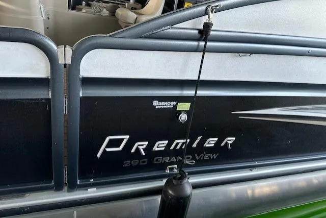 Slide: The Image of 2019 Premier 290 Grand View boat side view with branding and fender. - 16