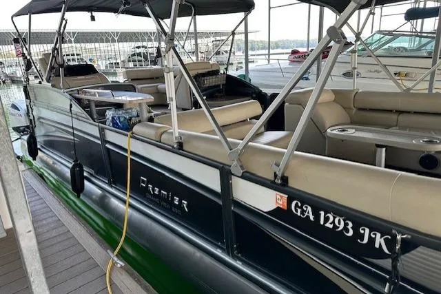 Slide: The Image of 2019 Premier 290 Grand View pontoon boat docked, featuring spacious seating and canopy. - 21