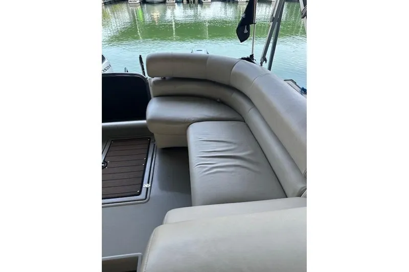 Slide: The Image of 2019 Premier 290 Grand View boat with beige seating, docked by calm water. - 7
