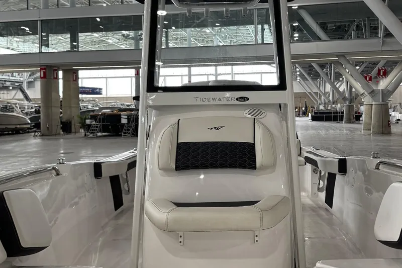 Slide: The Image of 2026 Tidewater 198 CC Adventure boat interior with steering wheel, showcased in a modern exhibition hall. - 14