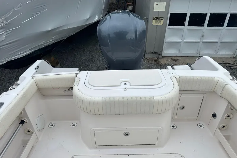 Slide: The Image of 2000 Grady-White Advance 247 boat interior with cushioned seating and storage compartments. - 11