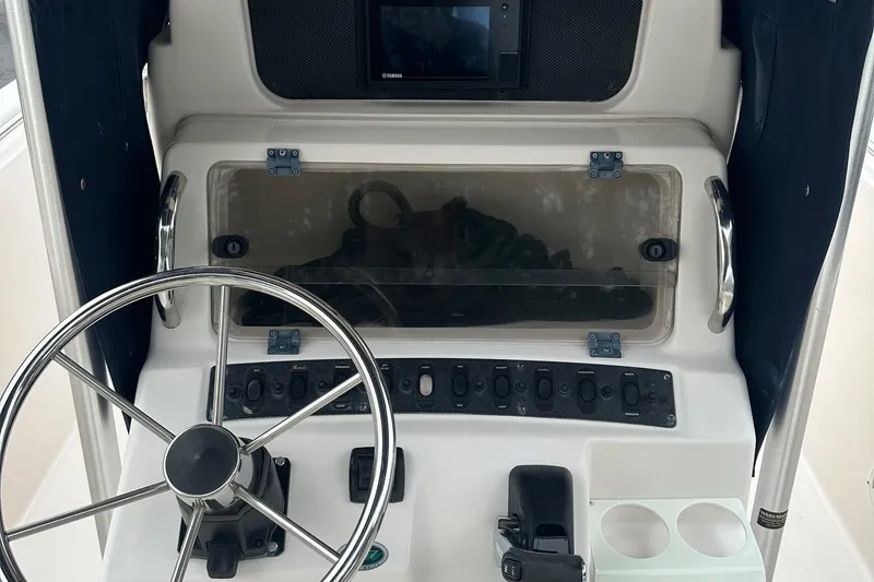 Slide: The Image of Control panel of a 2000 Grady-White Advance 247 boat with steering wheel. - 3