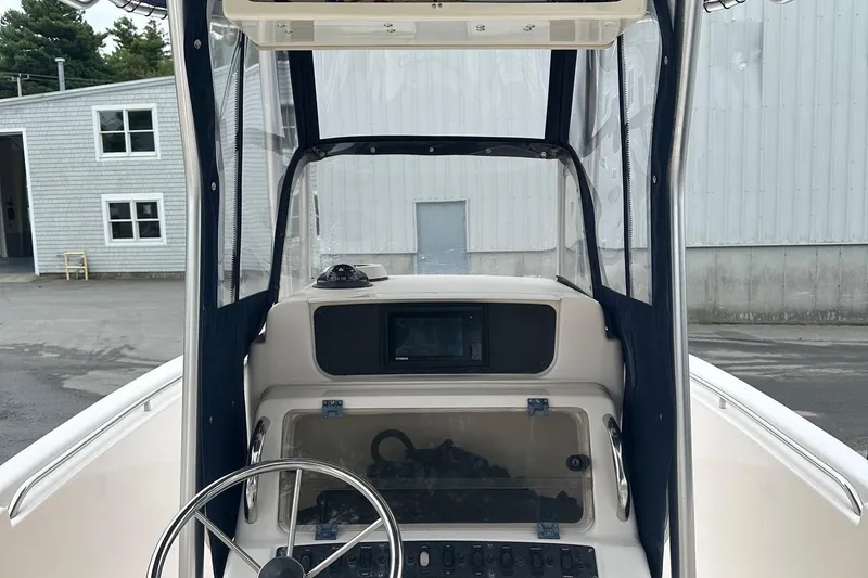 Slide: The Image of 2000 Grady-White Advance 247 boat cockpit with steering wheel and control panel. - 4