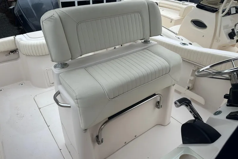 Slide: The Image of Interior of a 2000 Grady-White Advance 247 boat, featuring white cushioned seating. - 9