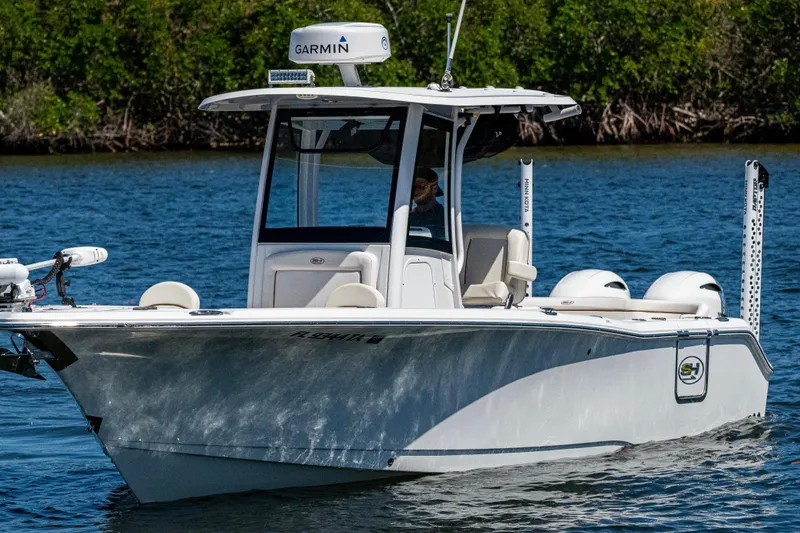 Slide: The Image of 2022 Sea Hunt Ultra 265 SE boat on water, equipped with Garmin technology. - 13