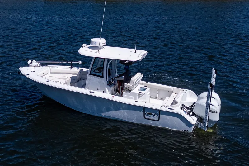 Slide: The Image of 2022 Sea Hunt Ultra 265 SE boat on calm water, side view. - 16