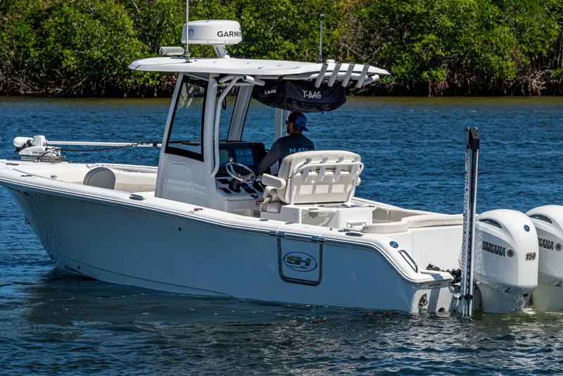 Slide: The Image of 2022 Sea Hunt Ultra 265 SE boat on water, featuring dual Yamaha engines. - 2
