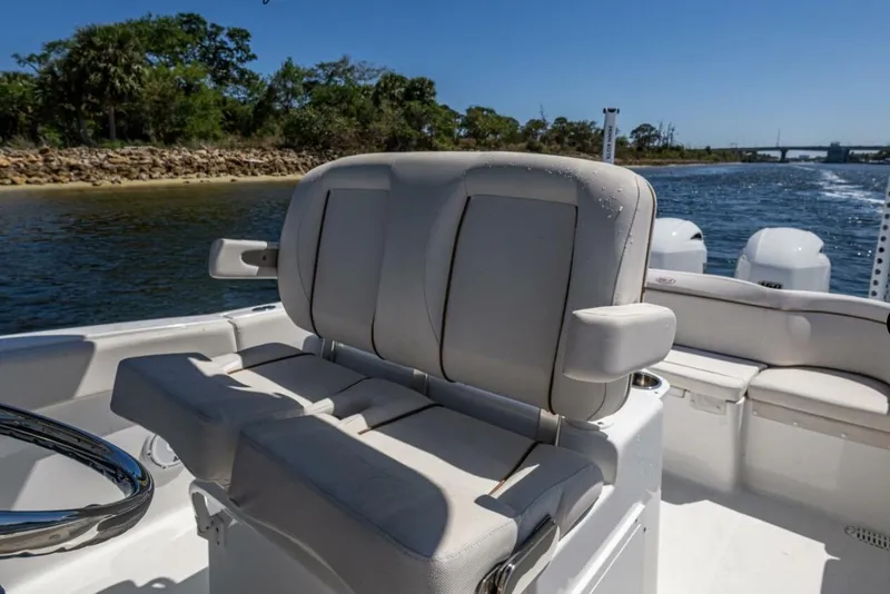 Slide: The Image of 2022 Sea Hunt Ultra 265 SE boat interior with comfortable seating and scenic waterway view. - 4