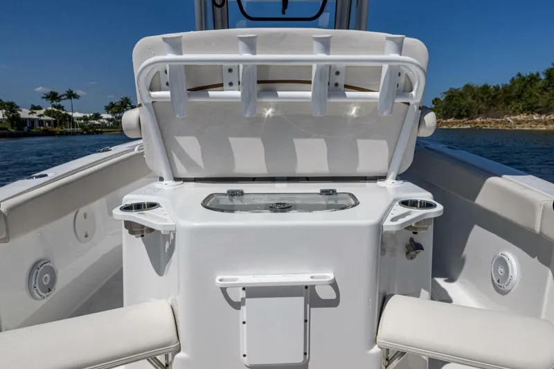 Slide: The Image of 2022 Sea Hunt Ultra 265 SE boat interior with seating and rod holders. - 9
