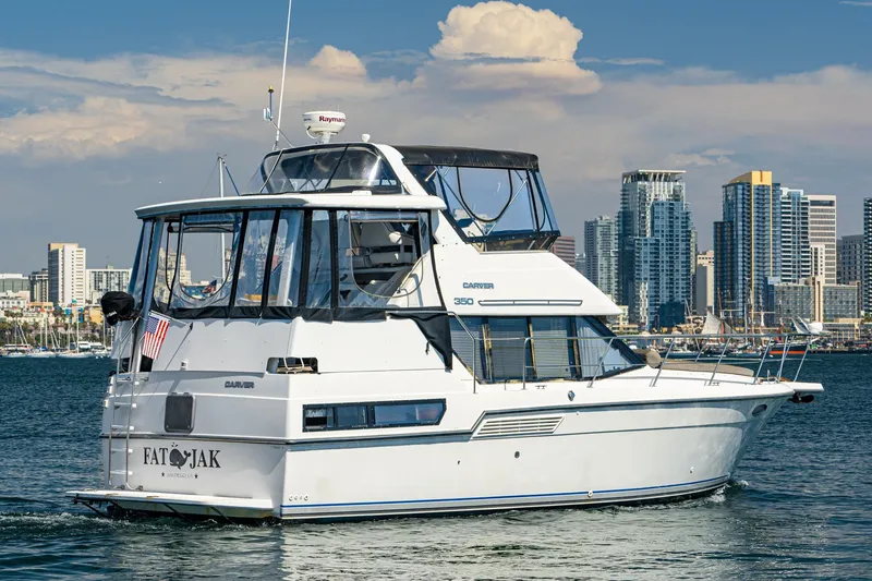 The Image of 1993 Carver 350 Aft Cabin Motor Yacht cruising near city skyline. - 1