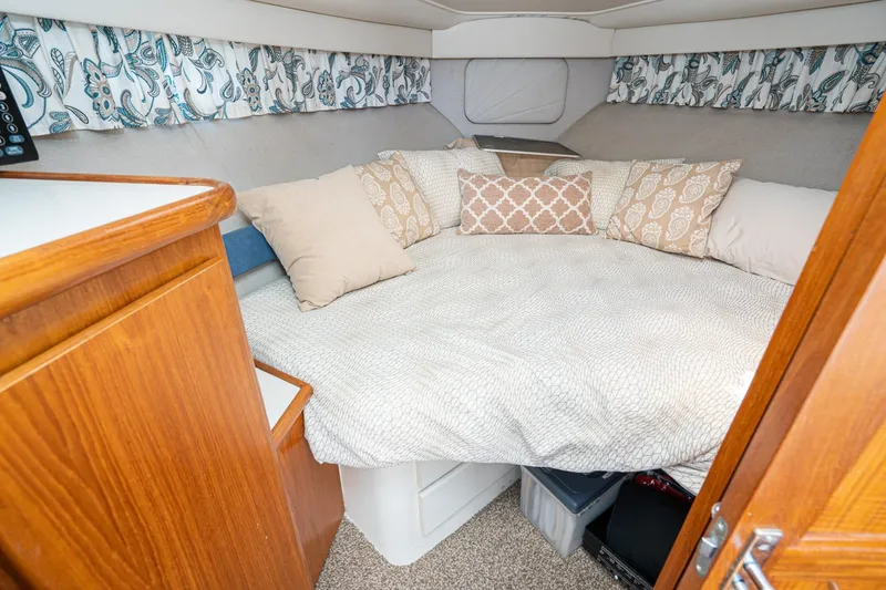 Slide: The Image of Cozy cabin interior of 1993 Carver 350 Aft Cabin Motor Yacht with decorative pillows. - 12