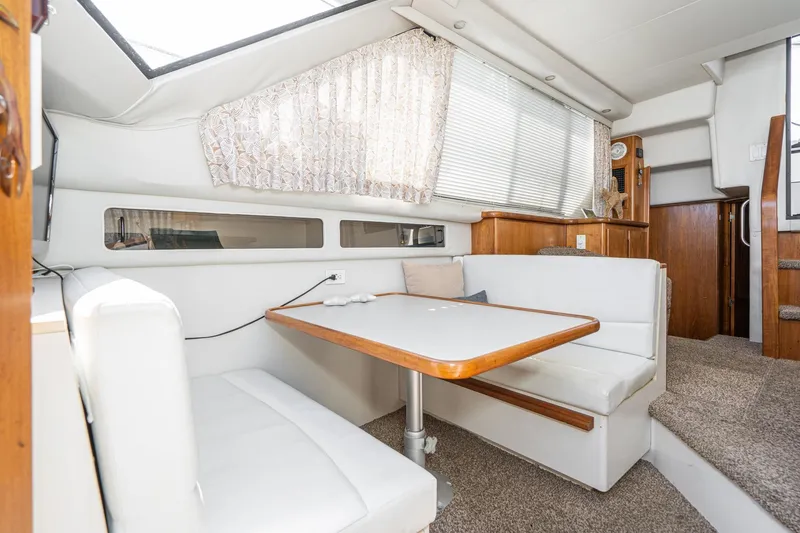Slide: The Image of Interior of 1993 Carver 350 Aft Cabin Motor Yacht with cozy dining area. - 16