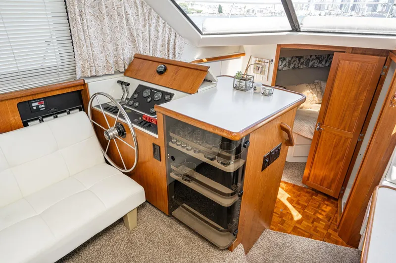 Slide: The Image of Interior of 1993 Carver 350 Aft Cabin Motor Yacht with helm, seating, and cabin entrance. - 17