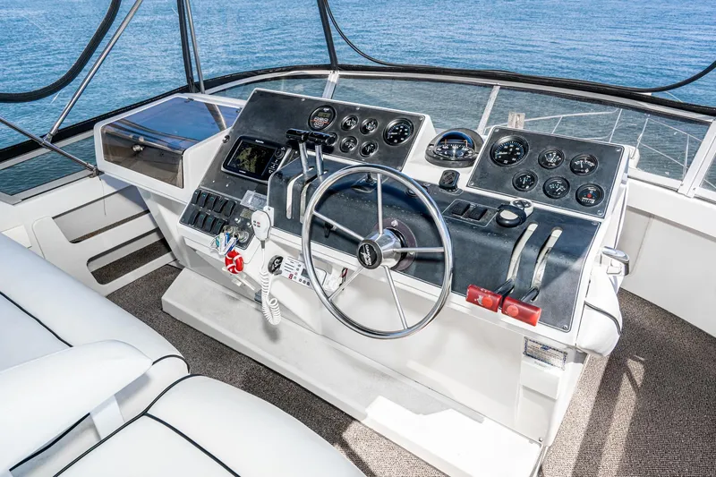 Slide: The Image of Cockpit of 1993 Carver 350 Aft Cabin Motor Yacht with steering wheel and control panel. - 22