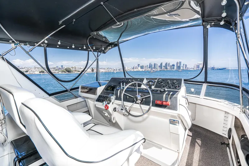 Slide: The Image of 1993 Carver 350 Aft Cabin Motor Yacht helm with city skyline view. - 23