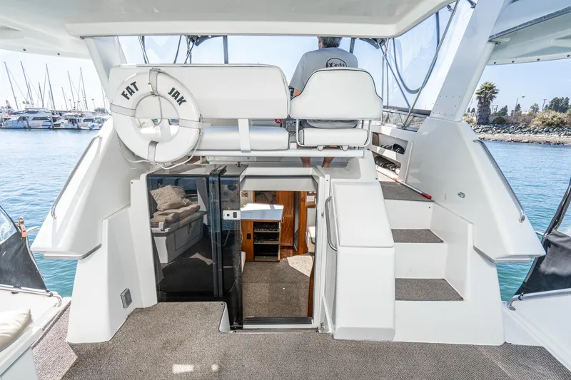 Slide: The Image of 1993 Carver 350 Aft Cabin Motor Yacht interior with helm, stairs, and marina view. - 24