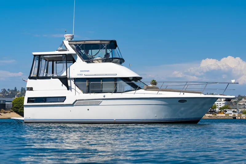 Slide: The Image of 1993 Carver 350 Aft Cabin Motor Yacht on calm water, clear sky background. - 28