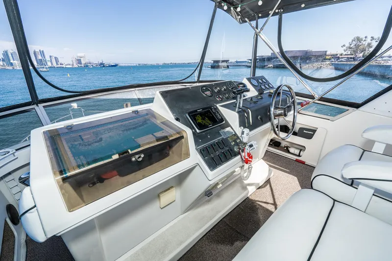 Slide: The Image of 1993 Carver 350 Aft Cabin Motor Yacht helm with city skyline view. - 3