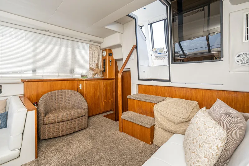 Slide: The Image of Interior of 1993 Carver 350 Aft Cabin Motor Yacht with cozy seating and wooden accents. - 6