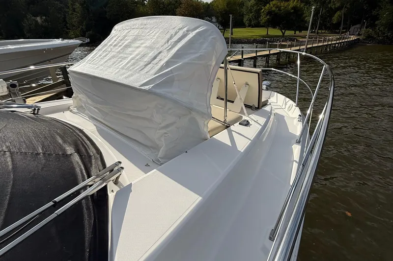 Slide: The Image of 2019 Regal 42 Fly yacht docked by a scenic waterfront. - 10