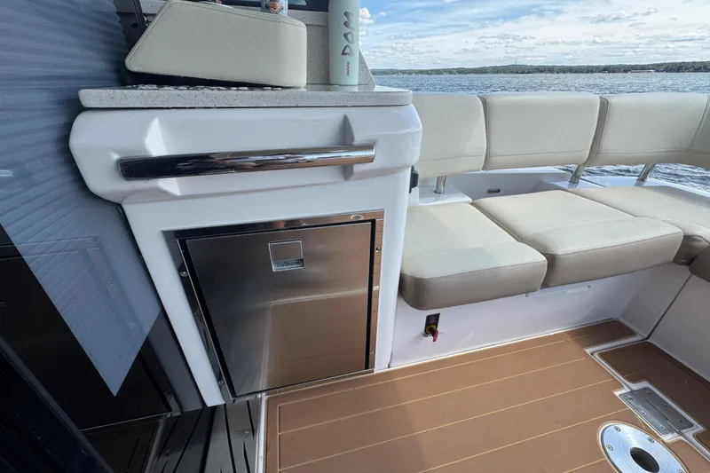 Slide: The Image of Luxurious 2019 Regal 42 Fly yacht interior with seating and mini fridge. - 21